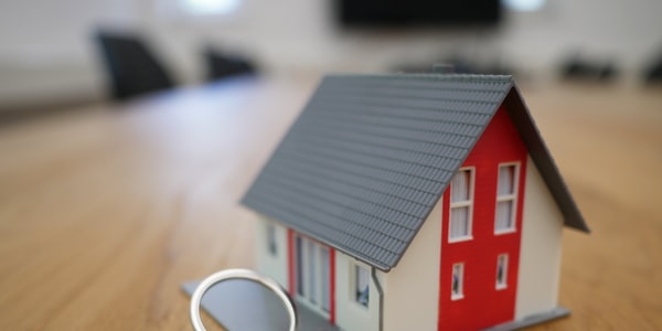 a miniature house keychain on the table